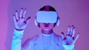 A person wears a VR headset in a pink and purple room