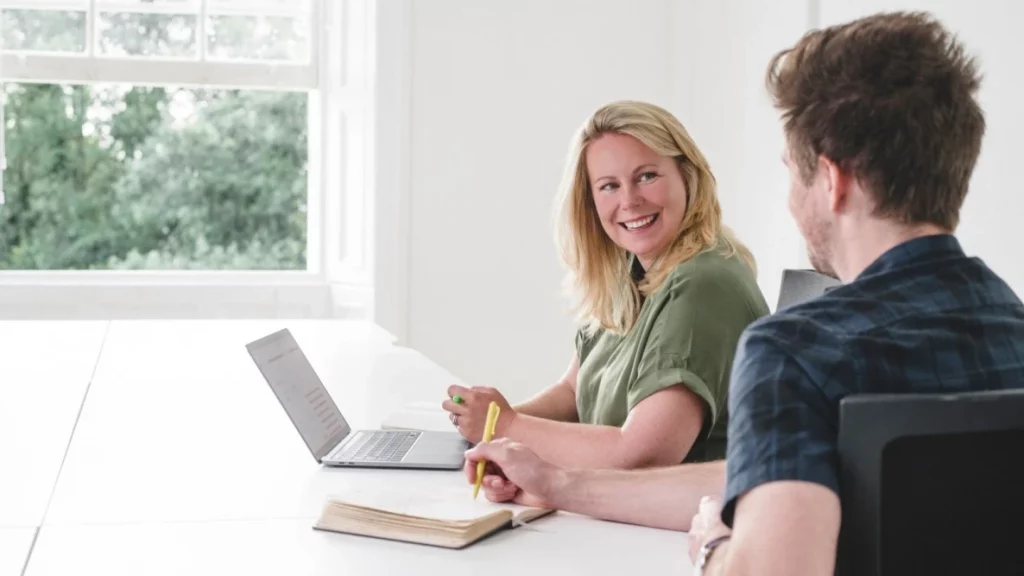 Launch Online Founder Jaye speaking with colleague