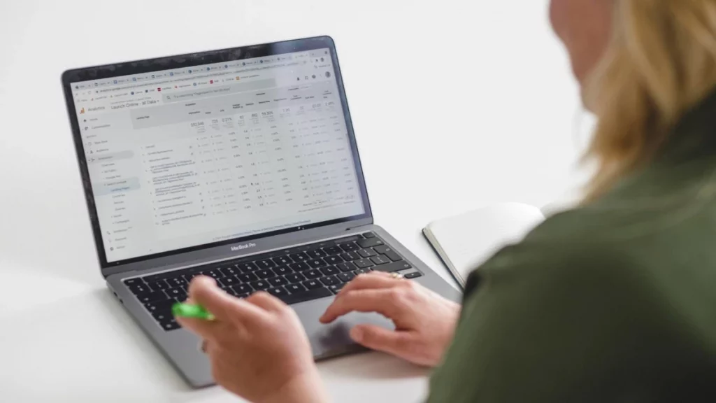 Back of a person using a laptop with Google Analytics on the screen