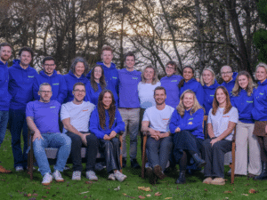 Launch team sits on the grass smiling