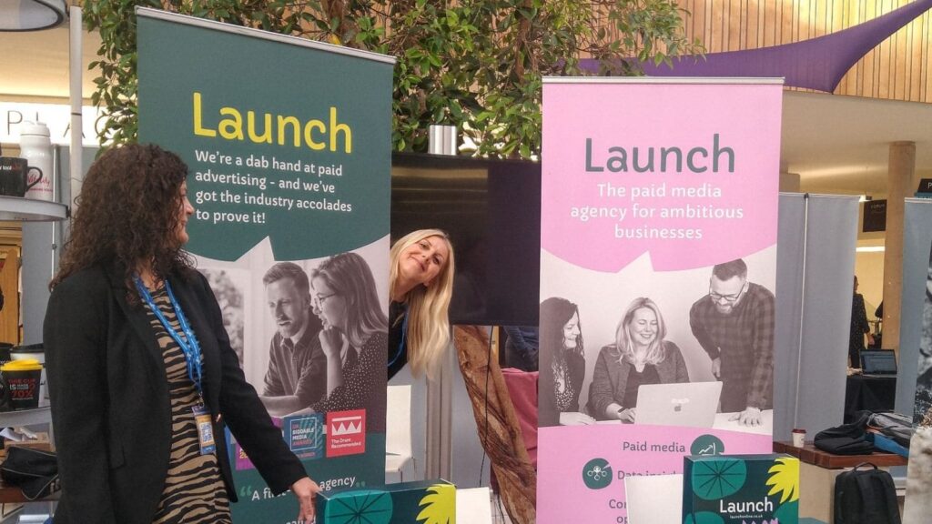 Steph and Becky pose at the Launch stand at Building Brands