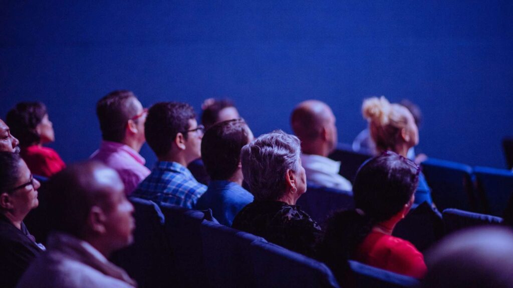 An audience in a lecture theatre listening