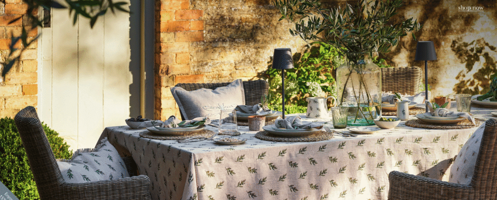 Image shows outdoor dining area styled with homewares by Sophie Allport