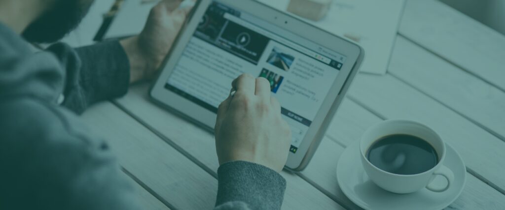 Someone scrolls the latest news on their ipad